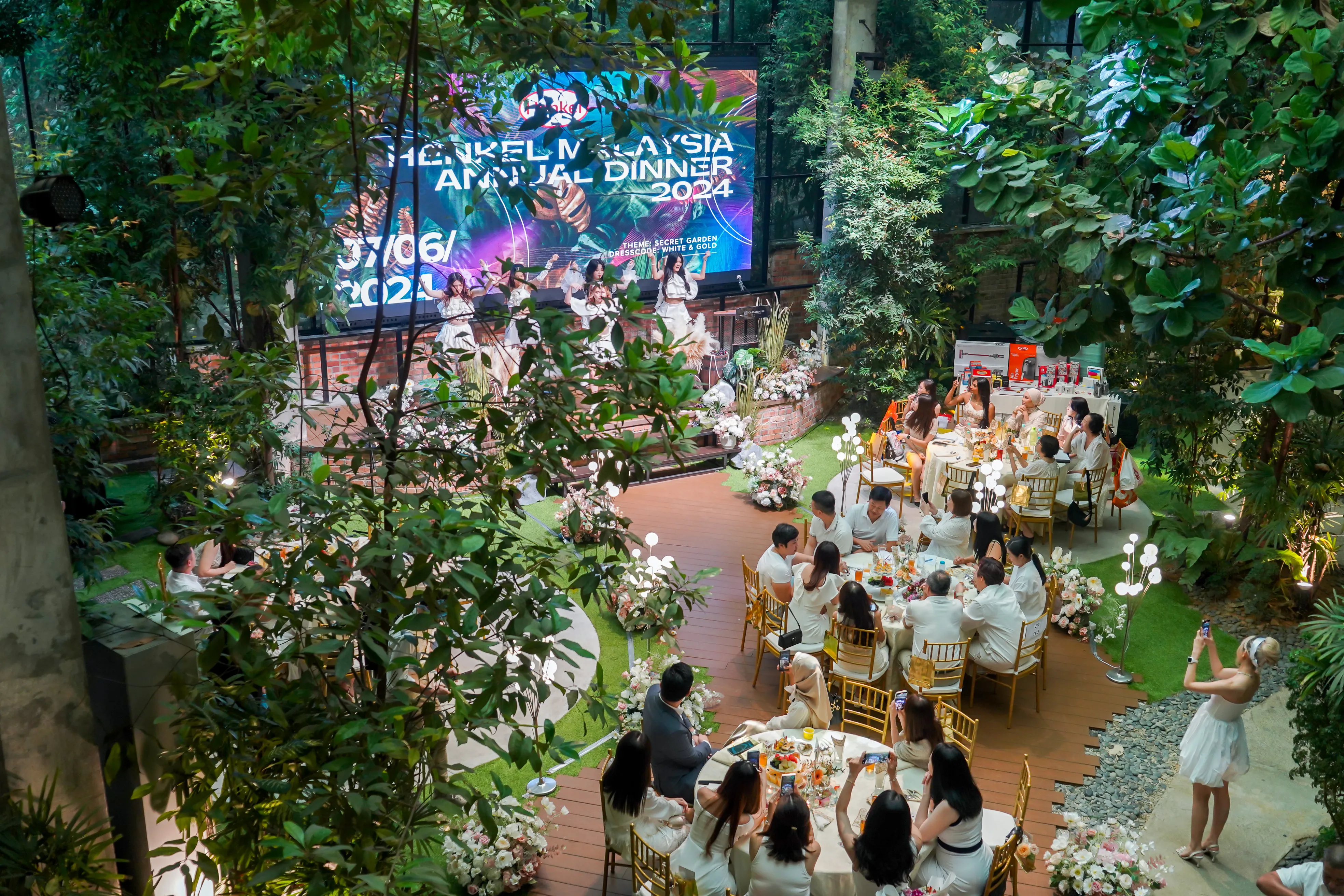 Corporate annual dinner stage and dining setup with guests