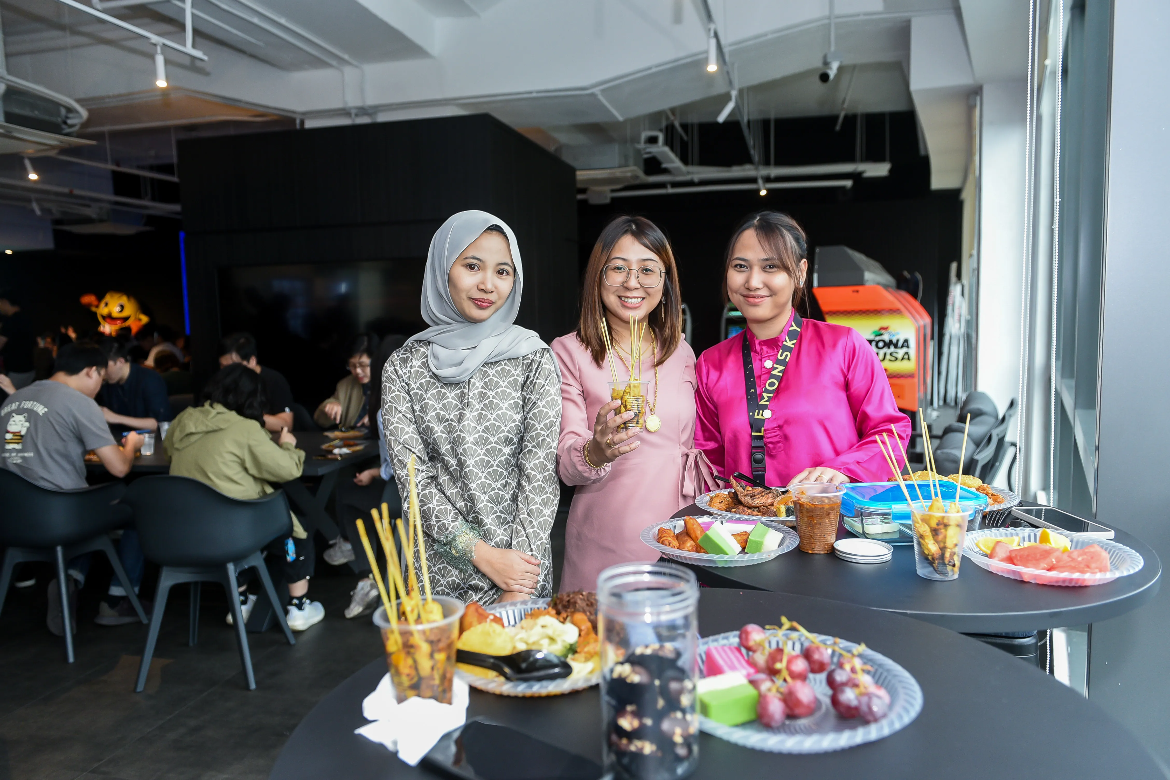 Staff posing with catered food at an appreciation event