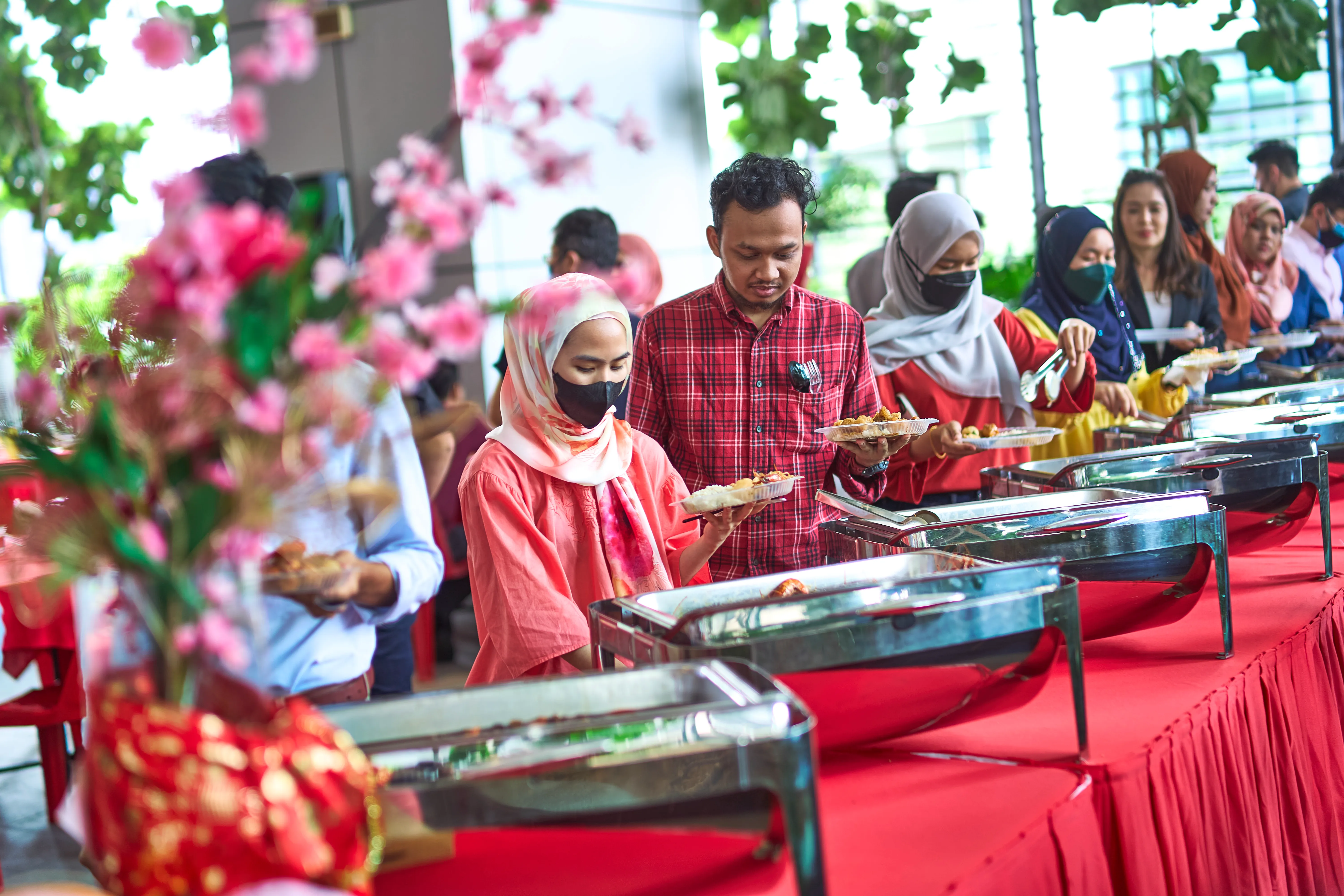 Guests queuing for Chinese New Year buffet catering at a festive event